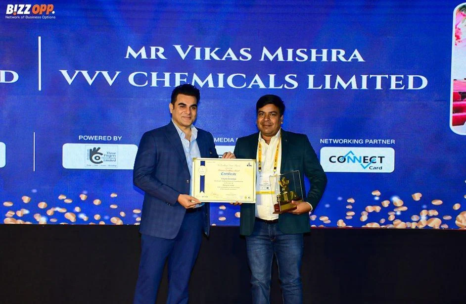 Vikas Mishra receiving a business award on stage